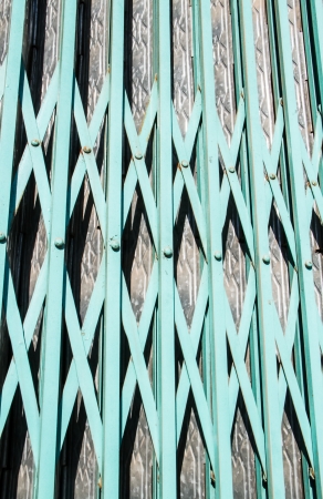 green iron door with sun light and shadowの写真素材