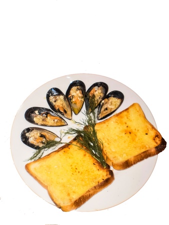Garlic bread with mussel on white dishの写真素材