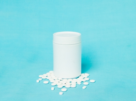 White medicine container on light  blue backgroundの写真素材