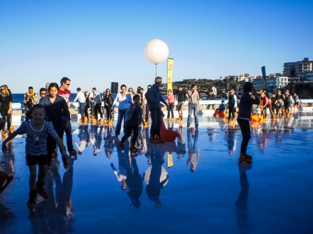 SYDNEY-JULY 3  People having fun with ice skating beside Bondi beach in  Sydney,Australia on 3 July 2012  Ice skating  will open beside Bondi beach in winter のeditorial素材