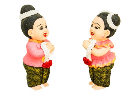 a girl and a boy doll make a respect on white backgroundの写真素材