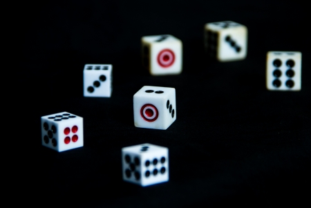 7 dices with variety of number on black backgroundの写真素材
