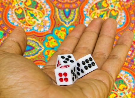 3 dices in the hand on indian graphic backgroundの写真素材