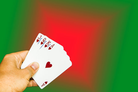 Cards holding by hand on red and green background