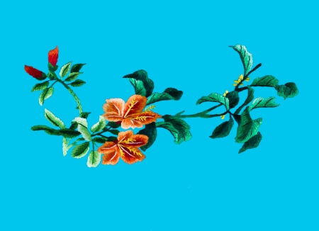 Silk flower sewing by hand on blue background の写真素材