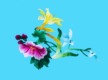 Silk flower sewing by hand on blue background の写真素材