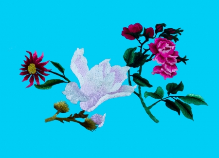 Silk flower sewing by hand on blue background の写真素材