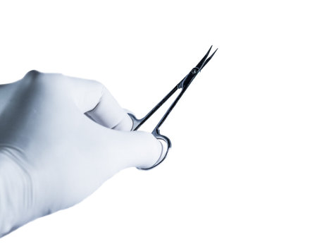 Scissors holding by hand on the white background.