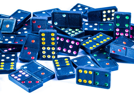 Black domino with colorful dots number on it .