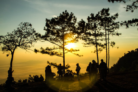 Sunrise on the mountain view with a group of people.