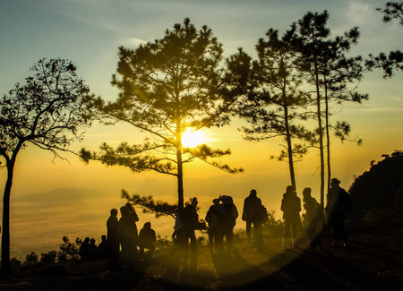 Sunrise on the mountain view with a group of people.