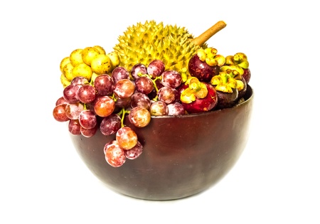 Various fruit in wood bowl on the white background.の写真素材