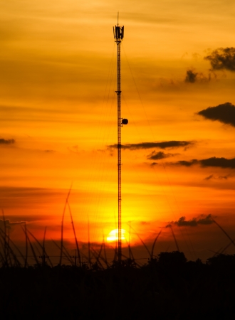 Cell phone tower silhouette with sunset background.の写真素材