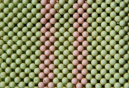 Green and pink related beads close up background.の写真素材