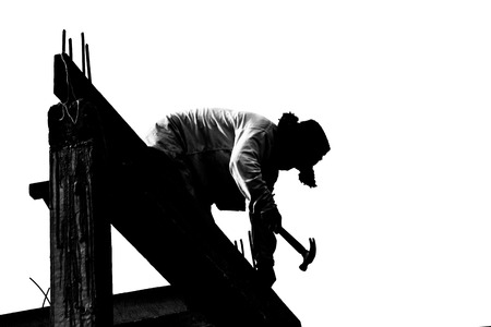 Silhouette of builder working on the white background.の写真素材