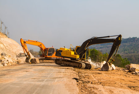 Loader excavators moving the rock from the road.