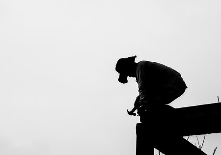 Silhouette of builder working on the white background.の写真素材