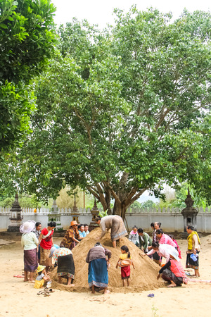 SAVANNAKHET,LAOS-APRIL 16 : Buddhist building sand castle in the temple to celebrate  Songkran festival in Savannakhet,Laos on April 16,2014.Songkran festival is Laos new year.のeditorial素材