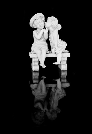 Marble sculpture of a girl kissing a boy  の写真素材