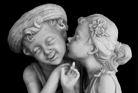 Marble sculpture of a girl kissing a boy .の写真素材