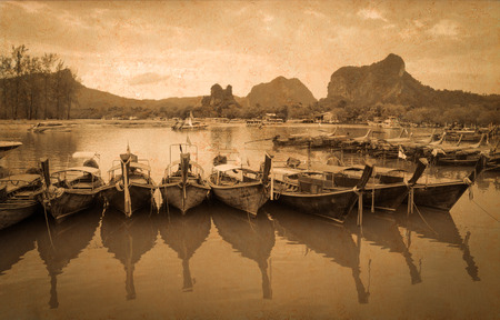VIntage photo of longtail boat in the sea.の写真素材