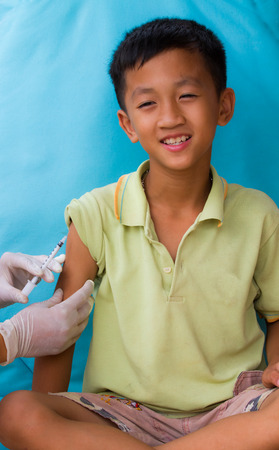Doctor injecting to a boy.の写真素材