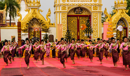 NAKHON PHANOM ,THAILAND-OCTOBER 8: A group of Thai dancers perform Thai dancing in front of Pratat Pranom pagoda on 8 October 2014 at Nakhon Pranom ,Thailand.Pratat Pranom pagoda is very important for buddhism.のeditorial素材