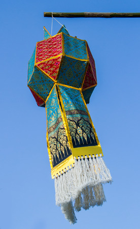 Thai style lantern hanging on blue sky background.の写真素材