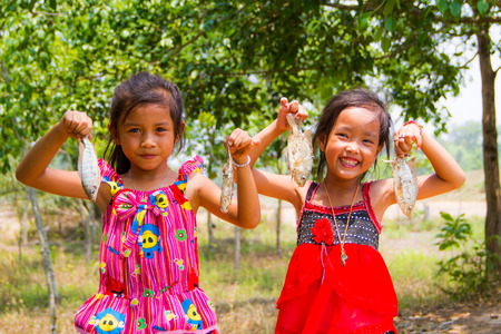 Two girls catch the fish.の写真素材