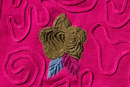 Flower sewing on pink fabric.