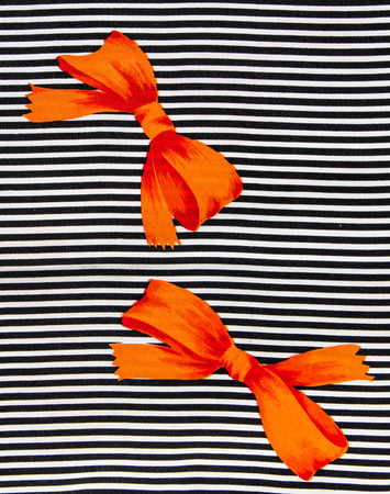 Orange bow on black and white strips.の写真素材
