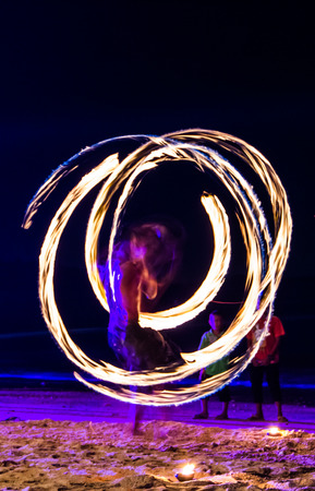 Swing fire show on the beach.の写真素材