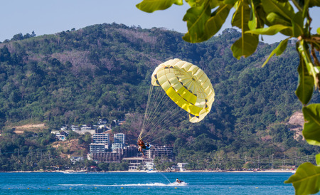People enjoy parasailing at Patong beach in Phuket,Thailand.のeditorial素材