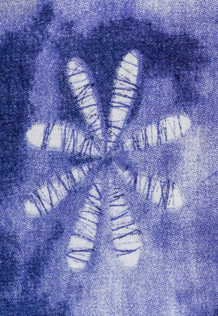 Abstract flower on blue fabric.
