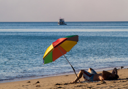 The guy lay down on the beach at Lanta island in Krabi,Thailand.の写真素材
