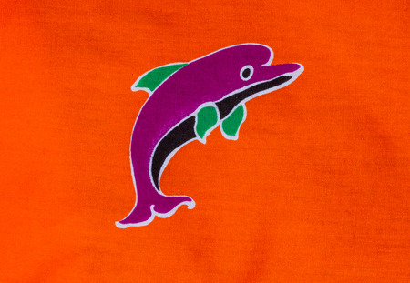 Dolphin print on orange fabric.の写真素材
