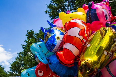 MAHASARAKHAM,THAILAND-AUGUST 22 : Various cartoon balloons available for sale to children in 150 year celebration of Mahasarakham province on August 22,2015.Cartoon balloons is one of  popular toy for children.のeditorial素材