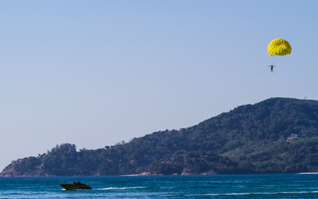 Phuket,Thailand-February 25 : People enjoy parasailing at  Patong beach in Phuket,Thailand on February 25,2015.Patong beach very popular for water sport.のeditorial素材