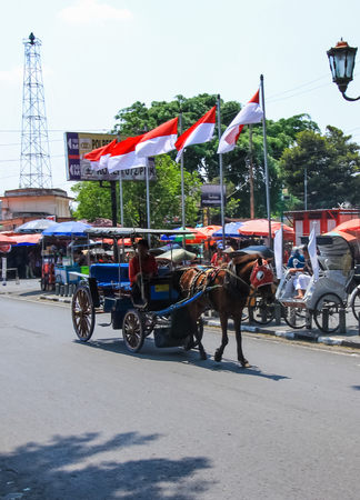 YOGYAKARTA, INDONESIA - AUGUST 27: View of Yogyakarta with horse-drawn vehicle on August 27,2016 in Yogyakarta, Indonesia.Horse-drawn available for service tourist around the city.のeditorial素材