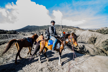 EAST JAVA, INDONESIA - AUGUST 25: Tourist riding the horse to Mount Bromo volcano on August 25,2016 in East Java, Indonesia.のeditorial素材