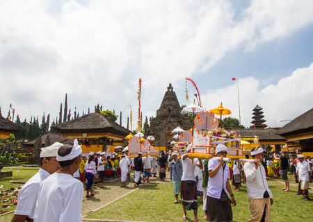 BALI,INDONESIA-AUGUST 21 : Balinese villagers participating in traditional religious Hindu procession in Pura Ulun Danu  Beratan  in Bali,Indonesia on August 21,2016.のeditorial素材