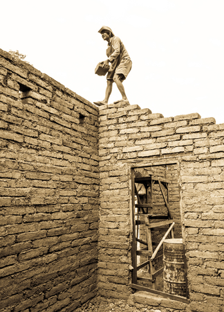Builder building earthen house by earthen brick.の写真素材