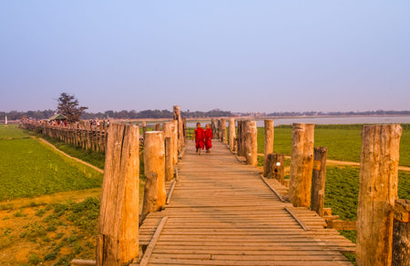 AMARAPURA,MYANMAR-MARCH 7:Neophytes walking on U bein bridge on March 7,2017 in Amarapura,Myanmar.U...