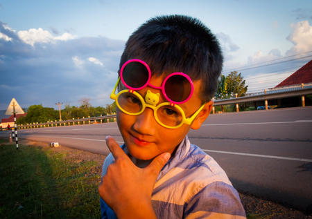 Asian boy wore fancy glasses.の写真素材