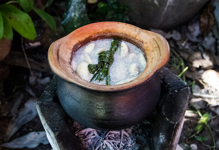 Banana in coconut milk cooking in earthen pot.の写真素材