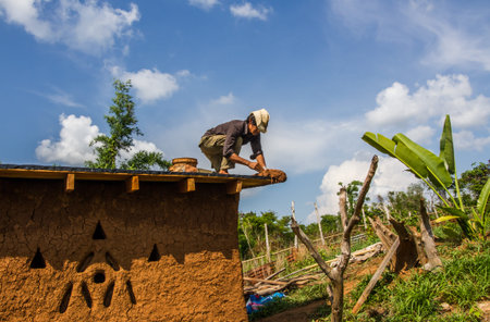 Buider making roof of mud house.の写真素材