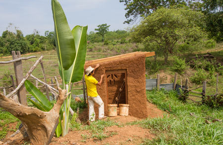 Buider making roof of mud house.の写真素材