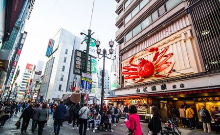 OSAKA, JAPAN -DECEMBER 1,2019: Visitors  walking at  Dotonbori street in the Namba District. This area is one of the most popular destination for tourist in Osaka city.のeditorial素材