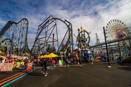 YAMANASHI,JAPANi - NOEMBER 24,2019: Unidentified fun people riding car on Roller coaster railway with Mount Fuji view and clear blue sky at Fuji-Q Highland amusement park.のeditorial素材