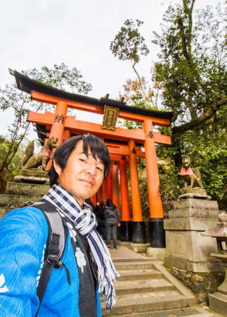 Tourist in front of Torii gate at Fushimi Inari shrine.のeditorial素材